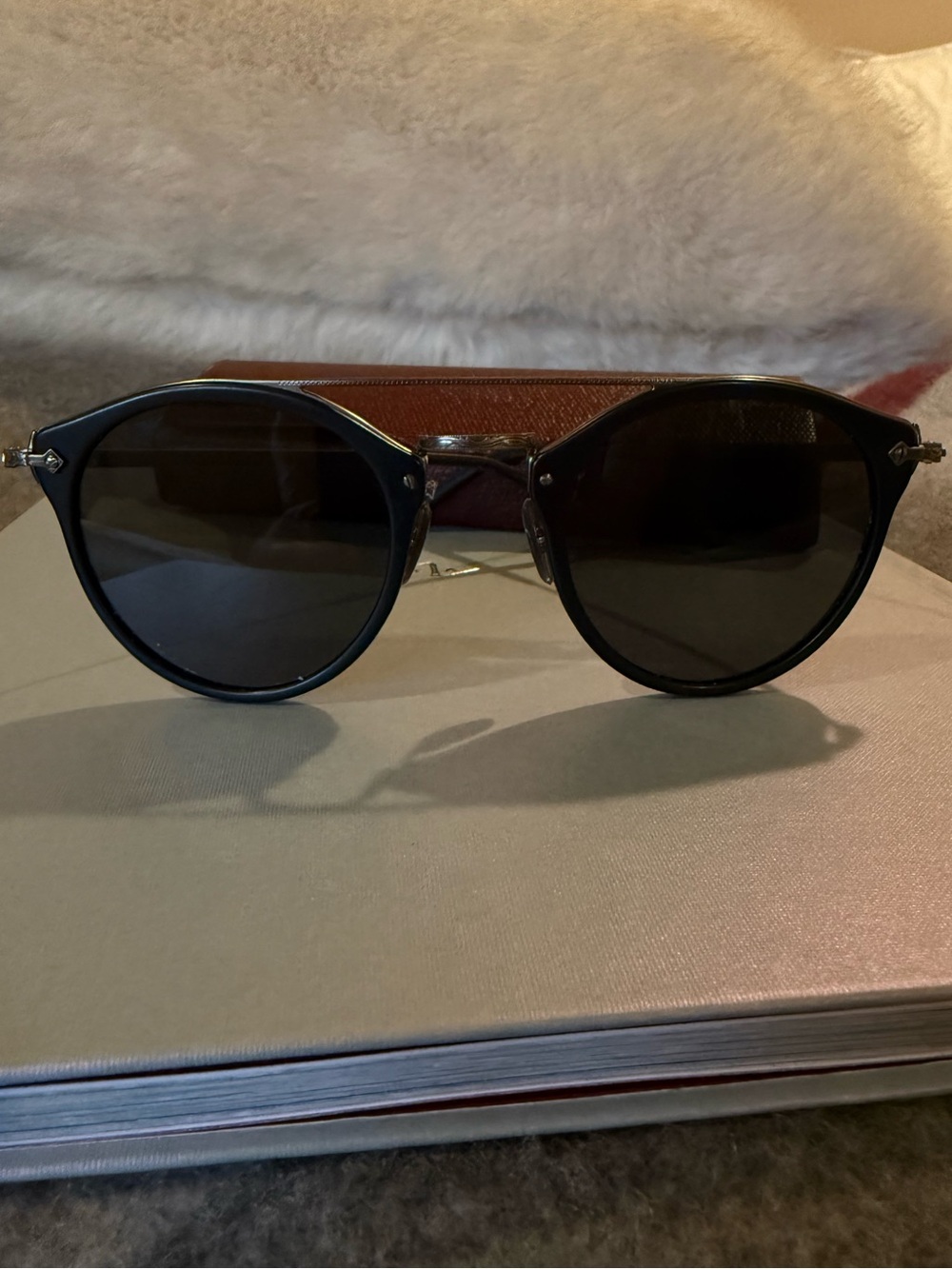 Oliver Peoples Black Round Sunglasses with Dark Lenses.